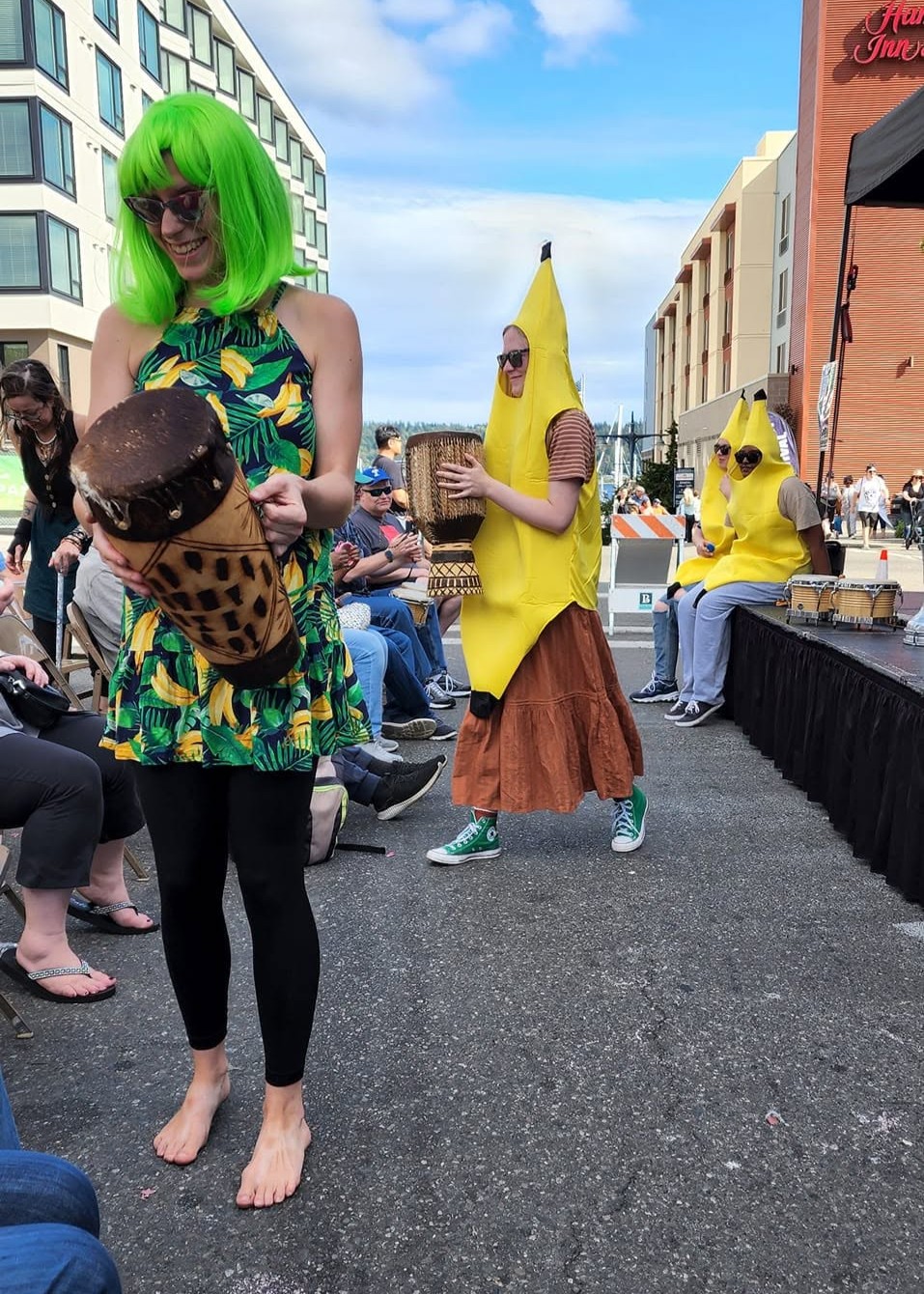 Hannah handing out drums to audience members.